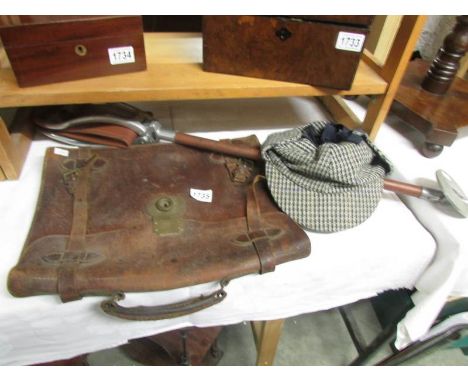 A vintage gamebird shooting stick, a tweed deer stalker hat and a leather briefcase.