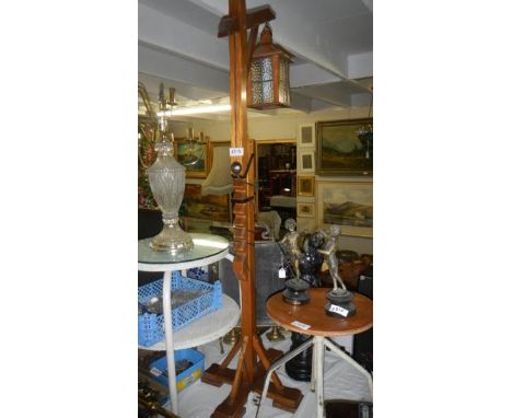 A large wooden adjustable floor standing lamp.