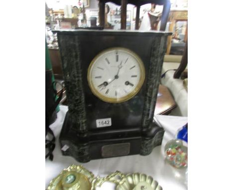 A black marble mantel clock.