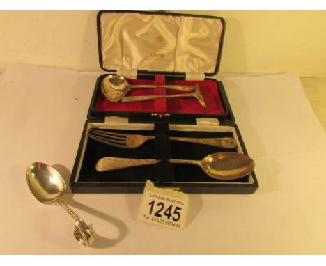 A cased silver fork & spoon, a cased silver spoon with pusher and one other silver spoon,.