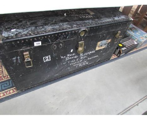 A large cabin trunk with brass lock.