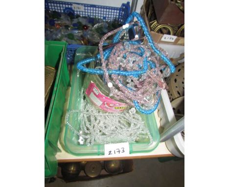 A tray of glass chandelier beads.