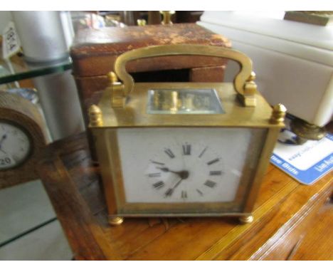A cased brass carriage clock.