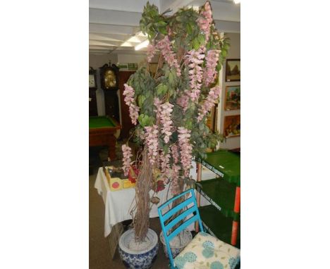 2 ceramic pots with artificial flowering trees.