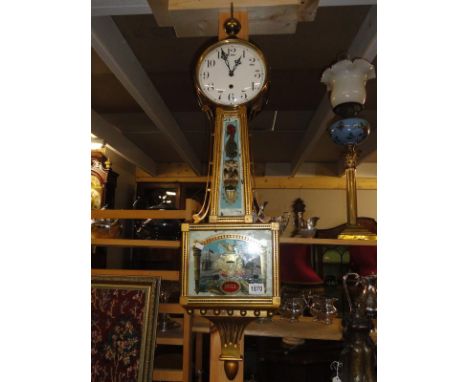 A 1906 'WAterbour' banjo clock, 8 day, single weight, reverse wind, painted verso 'Battle of Hull', USA.