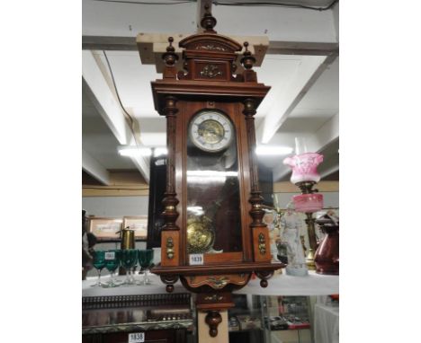 An art nouveau musical 8 day wall clock in walnut case, strikes on the hour.