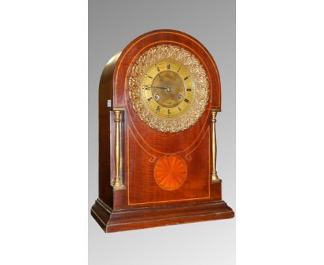 A French mahogany clock with shell inlay by Gilliot, Paris.