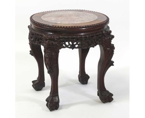 A Chinese rosewood low jardiniere stand, having a beaded circular marble inset top above a scroll leaf carved frieze, raised 