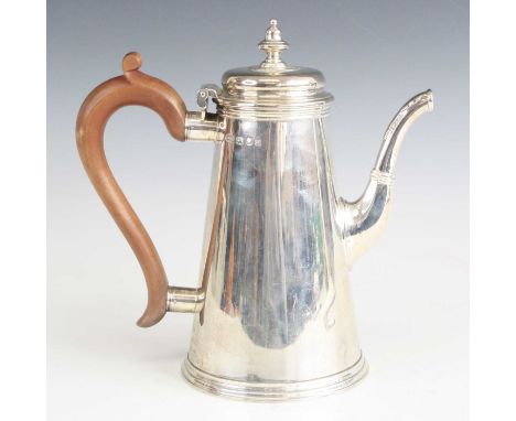 A Queen Anne style silver coffee pot, of conical form, having a finial topped hinged cover and walnut handle, maker Spink &am