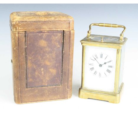 A late 19th century French lacquered brass carriage clock, having an unsigned white enamel Roman dial, push button hour repea