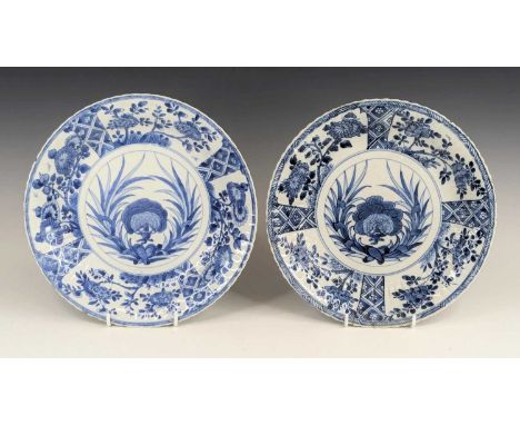 A pair of Chinese export blue and white porcelain dishes, Kangxi period, each decorated with panels of flowers upon a diaper 