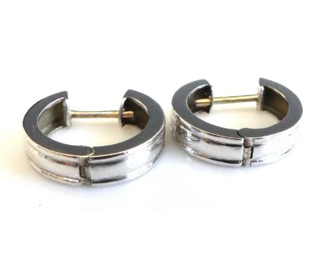 A pair of 9ct white gold hinged huggy hoop earrings, each with yellow gold posts, earring widths 4.2mm, inner diameters 18mm,