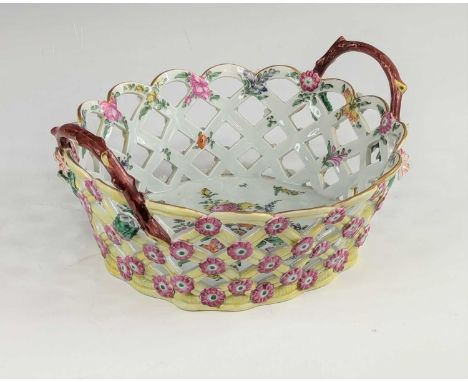 A Worcester porcelain table basket, circa 1770, flanked by twig handles and relief decorated with flowerheads, enamel decorat