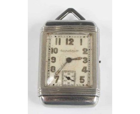 A circa 1930s Jaeger le Coultre Reverso steel cased mechanical pendant watch, with a rectangular white Arabic dial and subsid