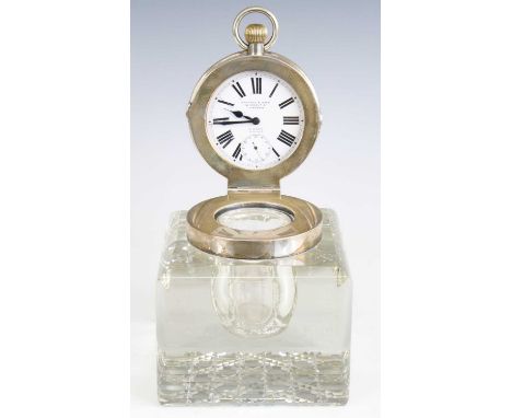 An Edwardian cut glass and silver topped inkwell, of good size, the silver hinged cover concealing a Goliath pocket watch by 