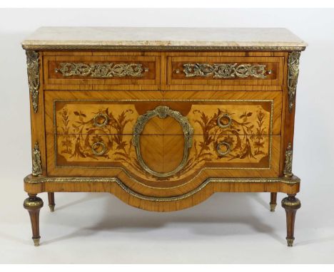 A French Empire style walnut and marquetry inlaid commode, having a marble top over two short and two long drawers, all with 