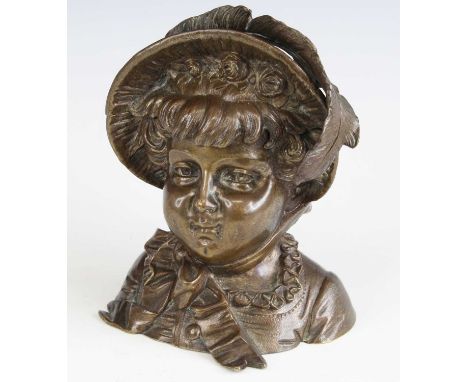 A late Victorian bronze inkwell, fashioned as a female bust wearing a peaked hat, with hinged action and glass liner, h.12.5c