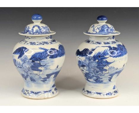 A pair of Chinese export blue and white porcelain jars and covers, each of baluster form, decorated with figures on a bridge,