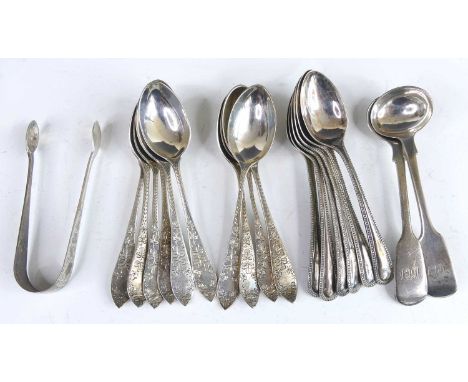 A set of ten Irish Edwardian silver teaspoons with matching sugar tongs, each stem bright cut engraved with textured clover l