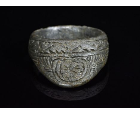 A decorated bronze ring referred to as an archer’s ring or thumb ring; used to protect the nail of the archer's ; commonly us