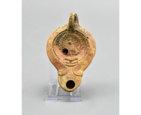 Ca. 100 – 300 AD. Ancient moulded clay oil lamp with circular panel depicting a peacock. The oil lamp is from the famous Germ