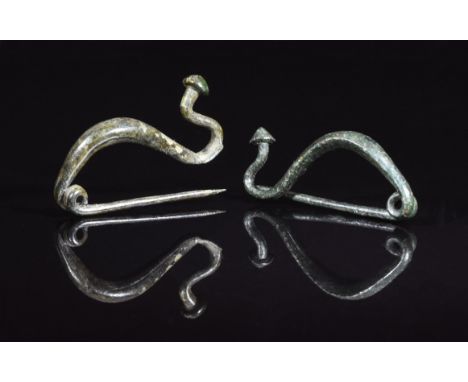 Ca. 300 BC. Interesting pair of Celtic, Iron Age, la tene type bow brooches. Expertly cleaned and conserved with smooth green