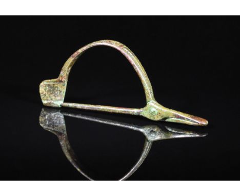 Ca. 100 AD. Interesting Ancient Bow fibula with decorated arch section; front terminal used as cosmetic tweezers. Expertly cl