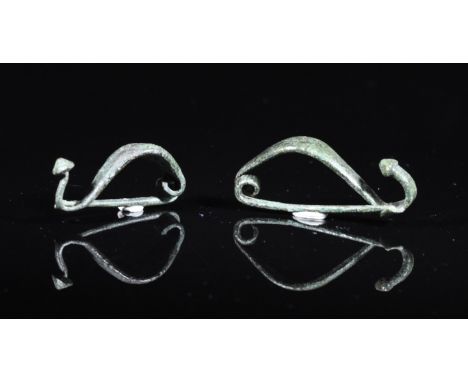 Ca. 300 BC. Interesting pair of Celtic, Iron Age, la tene type bow brooches. Expertly cleaned and conserved with smooth green