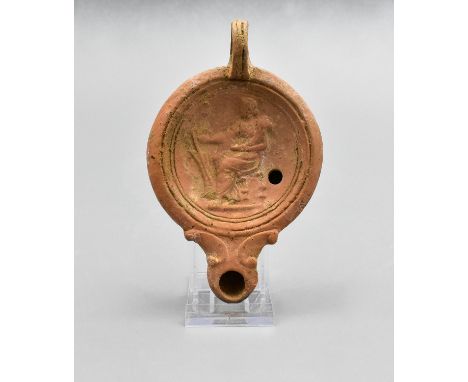 Ca. 200 AD. Ancient moulded clay oil lamp with circular panel depicting seated Fortuna. The oil lamp is from the famous Germa