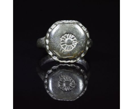 CA. 200 AD. Ancient cast bronze ring with round hoop; applied oval bezel depicting a sun motif – symbol of the god Salus Invi