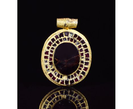 CA. 700 AD. Important Frankish gold disc pendant with decorated applied loop. The edge part of the pendant is elaborately dec