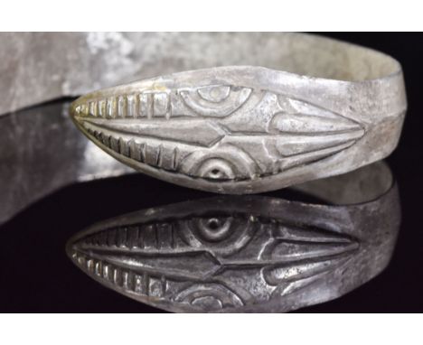 Ca.100 AD. A silver flat-section Armilla bracelet with slightly raised median band, the terminals depicting snake heads with 