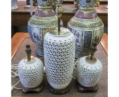 LAMPS, reticulated white ceramic of vase form together with a pair of small matching lamps all with carved hardwood bases and