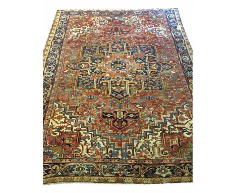 ANTIQUE SERAPI HERIZ CARPET, 335cm x 242cm, sapphire medallion on ruby field.