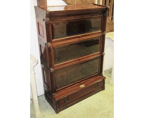 GLOBE WERNICKE BOOKCASE, George V mahogany with three sections, each with a rising bevelled glazed door above an oval retirem