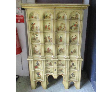 CHINOISERIE CABINET ON CHEST, decorated with birds, leaves, flowers and figures having two fluted doors above enclosing a she