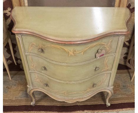 COMMODE, of serpentine form, with three drawers, green painted with Florentine style painted scrolls. 84cm H x 46cm D x 92cm 
