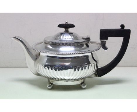 A Victorian silver bachelor's tea pot, by George Aldwinckle, London 1890, the compressed rectangular part fluted body raised 