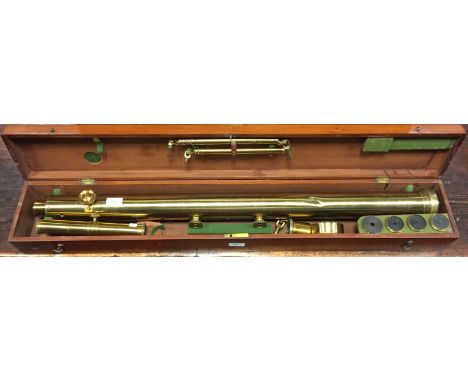An early 19th century laquered brass refracting telescope and tripod, with 6cm (2 1/4in) lens and various fittings and eyepie