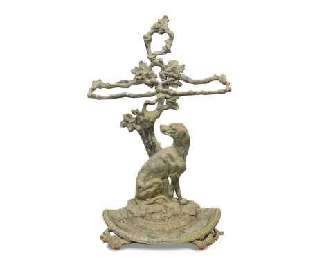 A Coalbrookdale style cast iron stick stand, of rustic branch design and seated hound and a bootscraper (2) 74 x 45cm (29 x 1