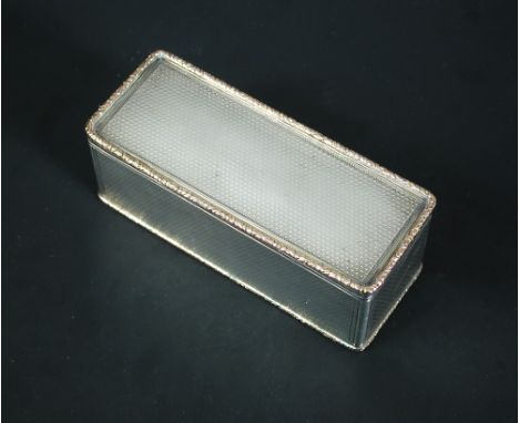 A large George IV silver snuffbox, maker W.?. London 1824, of rectangular shape, allover engine turned within gold floral edg
