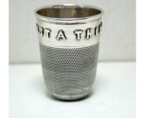 A Victorian silver spirit measure, by George Unite, Birmingham 1876, modelled as an outsized thimble with the applied motif '