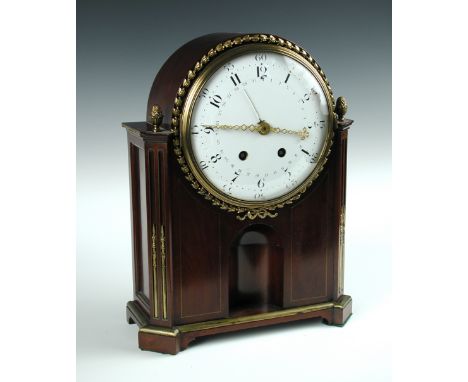 A mahogany cased mantle clock in the Directoire style, the 20cm (8in) enamelled dial with shaped hands and concentric calenda