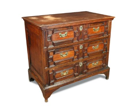 A 17th century walnut and pine chest of drawers, with geometric moulded drawer fronts, later brass handles, on stile legs and