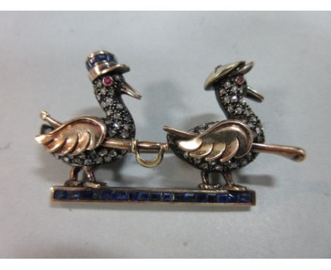 A 1930s French Tunisian diamond and sapphire 'gendarme' ducks novelty brooch, in the form of a calibré sapphire bar surmounte