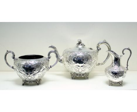 A Victorian silver three piece teaset, by Martin & Hall, London 1875, the teapot of tapered spherical shape embossed with flo