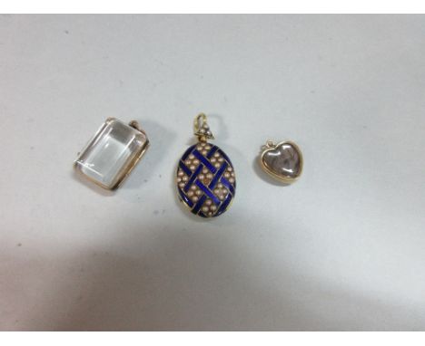 Three antique locket pendants, the first oval with seed pearls and blue enamel, the front with interwoven royal blue guilloch