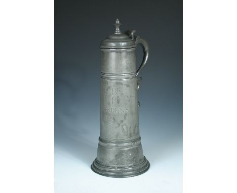 A pewter flagon inscribed 'RB. IP. Wardens 1753', the late 17th century style vessel with spire finial to the domed lid with 