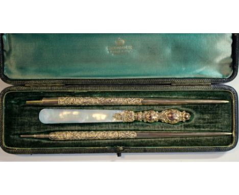 A Victorian 9ct gold three piece writing set, by William Harrison Walter, Birmingham 1897, comprising a dip pen, the tapering