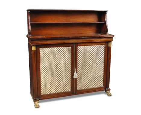 A Regency mahogany chiffonier, with raised shelf back and scrolling outline sides, above a base enclosed by satin and brass g